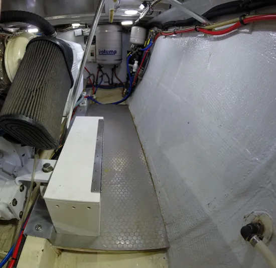 Wined Up Yacht Photos Pics Engine room of a 1973 Hatteras 53 yacht, featuring mechanical components and wiring.