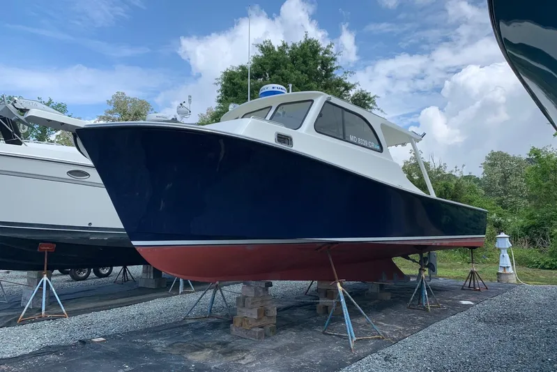  Yacht Photos Pics 2021 Composite Yacht CY32 Chesapeake on stands, blue hull, red bottom, outdoors.