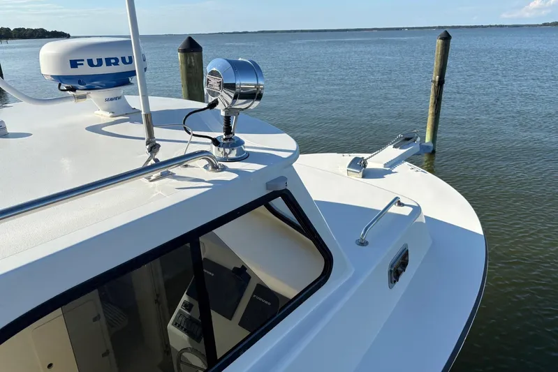 Yacht Photos Pics 2021 Composite Yacht CY32 Chesapeake docked, featuring radar and spotlight, with serene water backdrop.