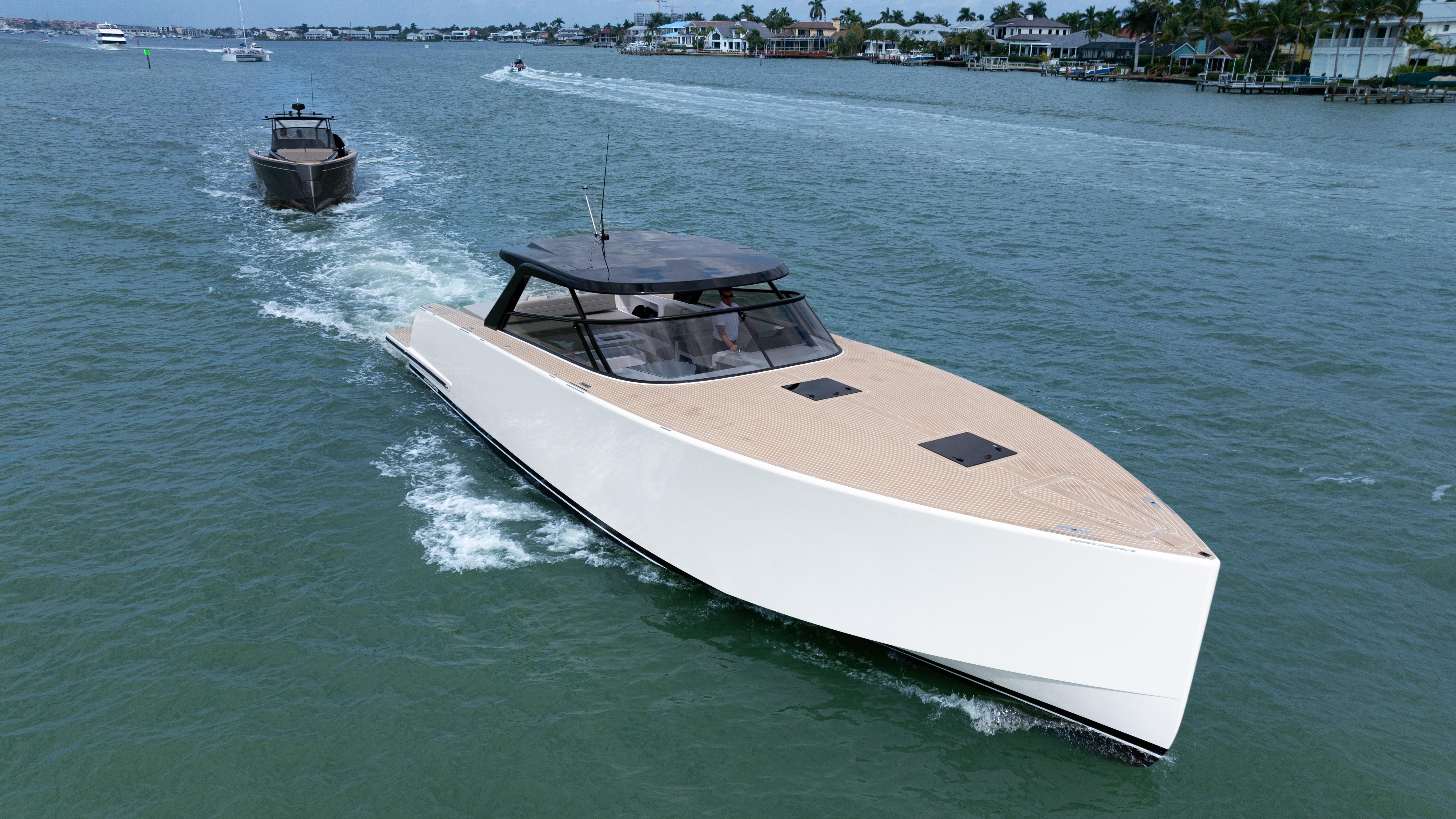 2024 VanDutch 56 luxury yacht cruising on a scenic waterway.