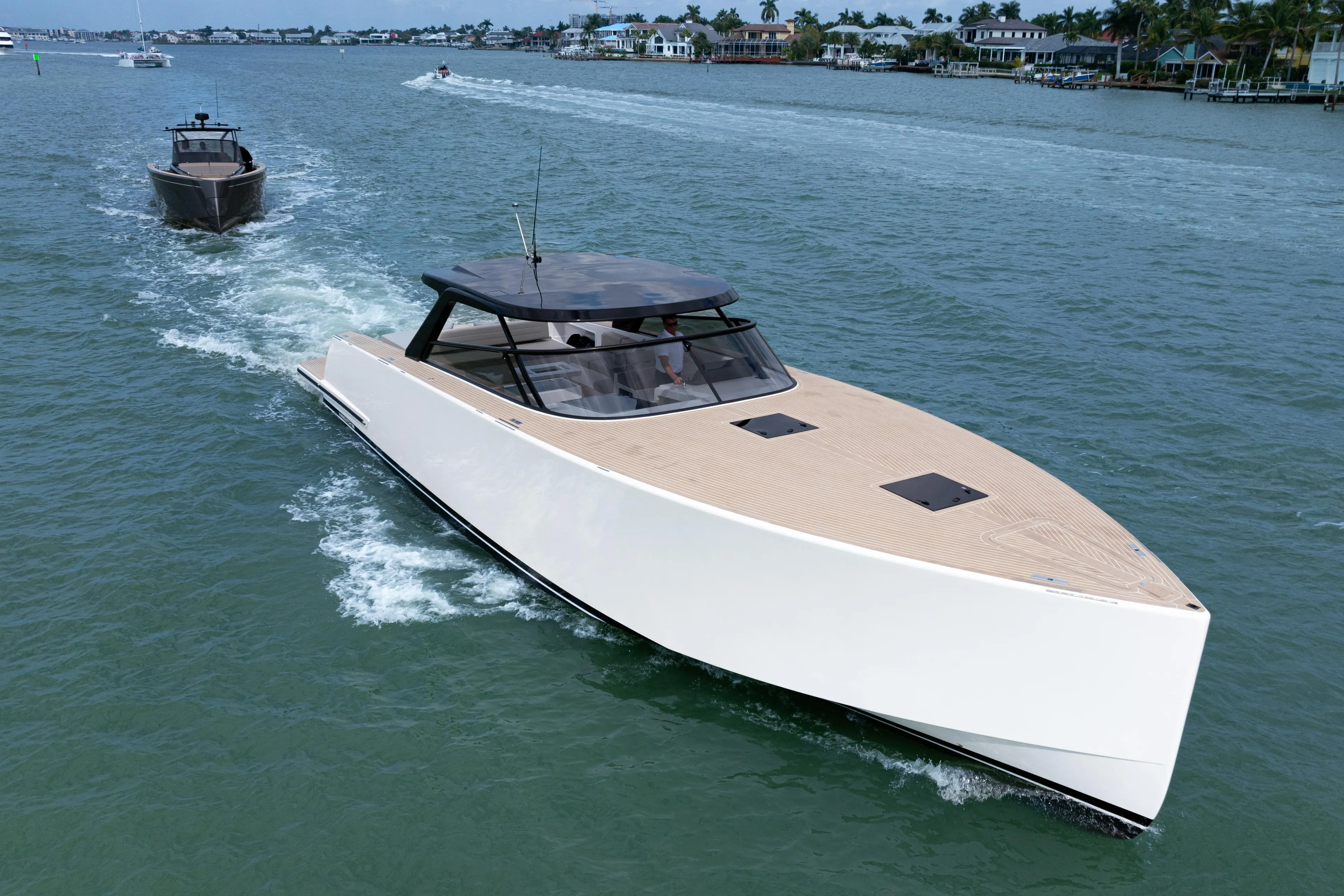 2024 VanDutch 56 luxury yacht cruising on a scenic waterway.