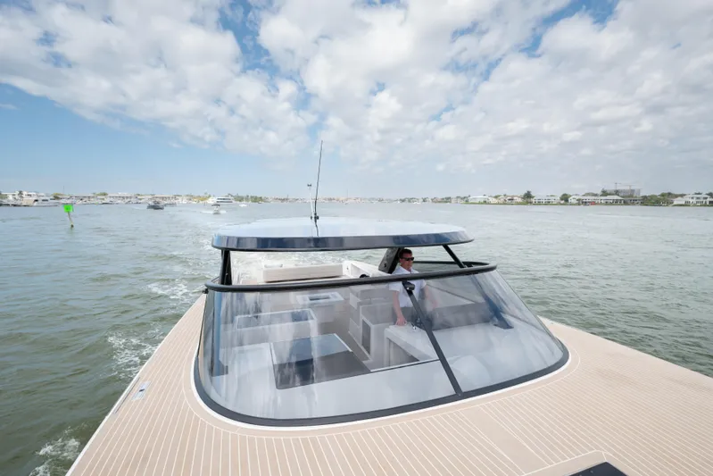  Yacht Photos Pics 2024 VanDutch 56 yacht cruising on open water under a partly cloudy sky.