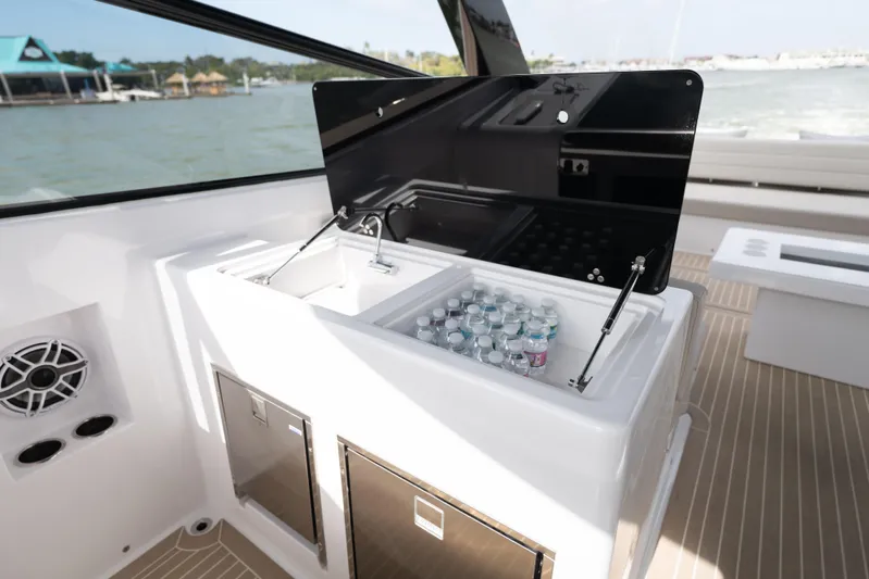  Yacht Photos Pics 2024 VanDutch 56 yacht interior with beverage cooler and storage compartments.