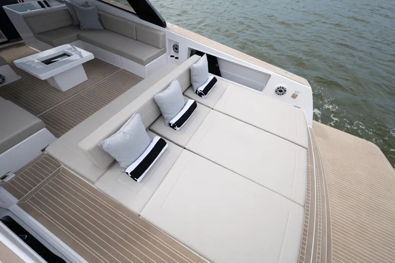  Yacht Photos Pics Luxurious 2024 VanDutch 56 yacht deck with elegant seating and cushions on the water.