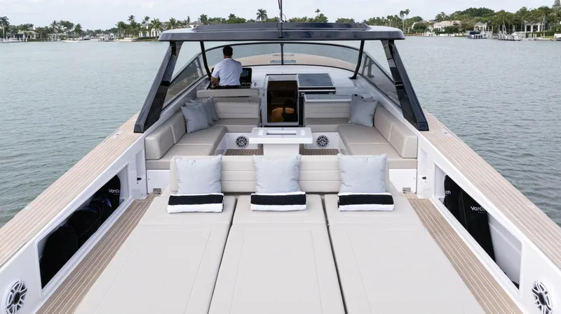  Yacht Photos Pics 2024 VanDutch 56 luxury yacht with spacious deck and elegant seating on calm waters.