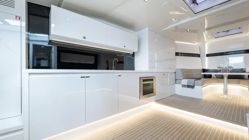  Yacht Photos Pics Luxurious interior of 2024 VanDutch 56 yacht with modern kitchen and seating area.