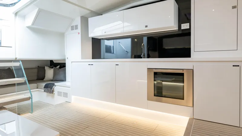  Yacht Photos Pics Luxurious interior of 2024 VanDutch 56 yacht with modern kitchen and seating area.