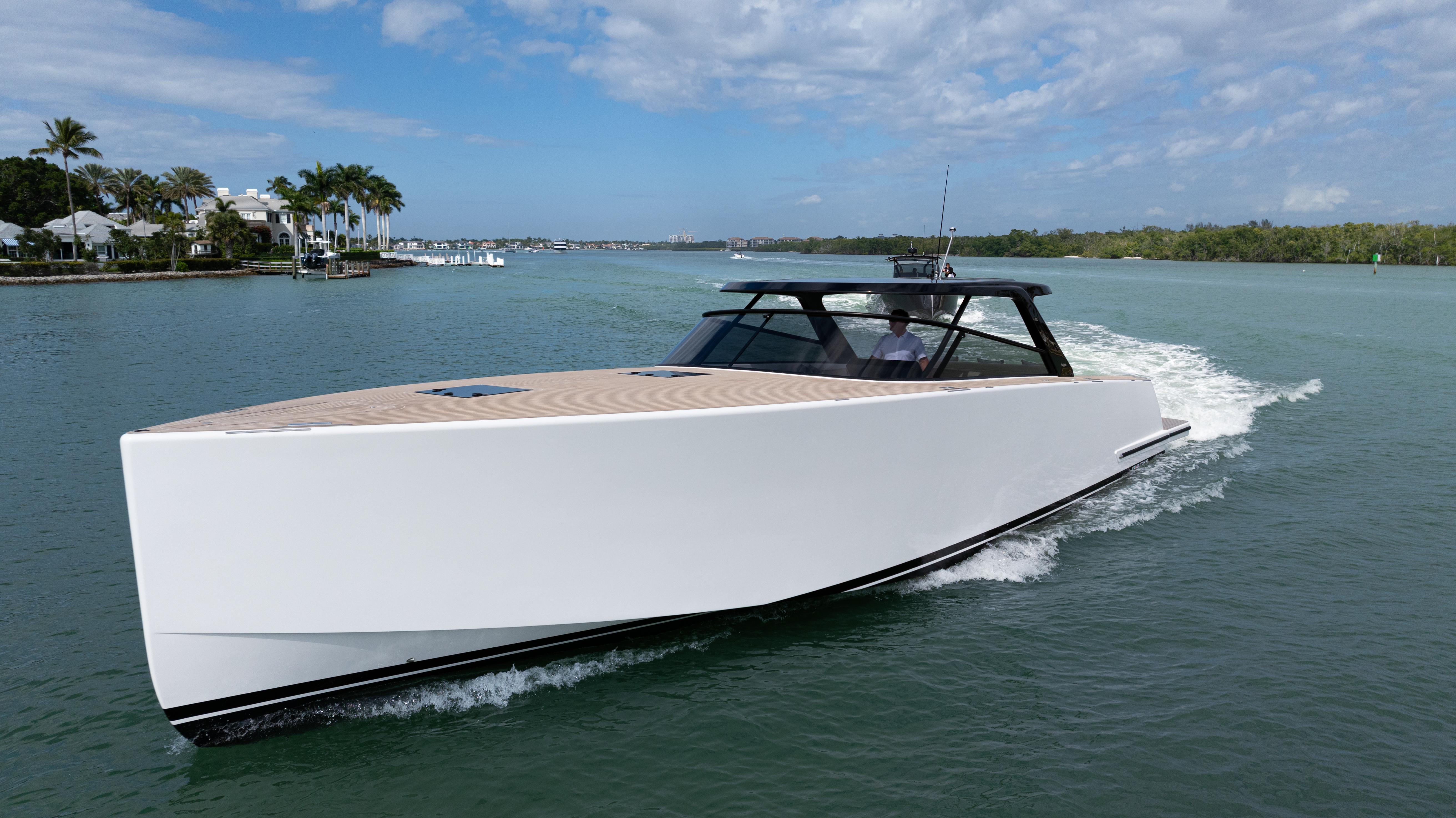 2024 VanDutch 56 yacht cruising on a sunny day, sleek design, open water.