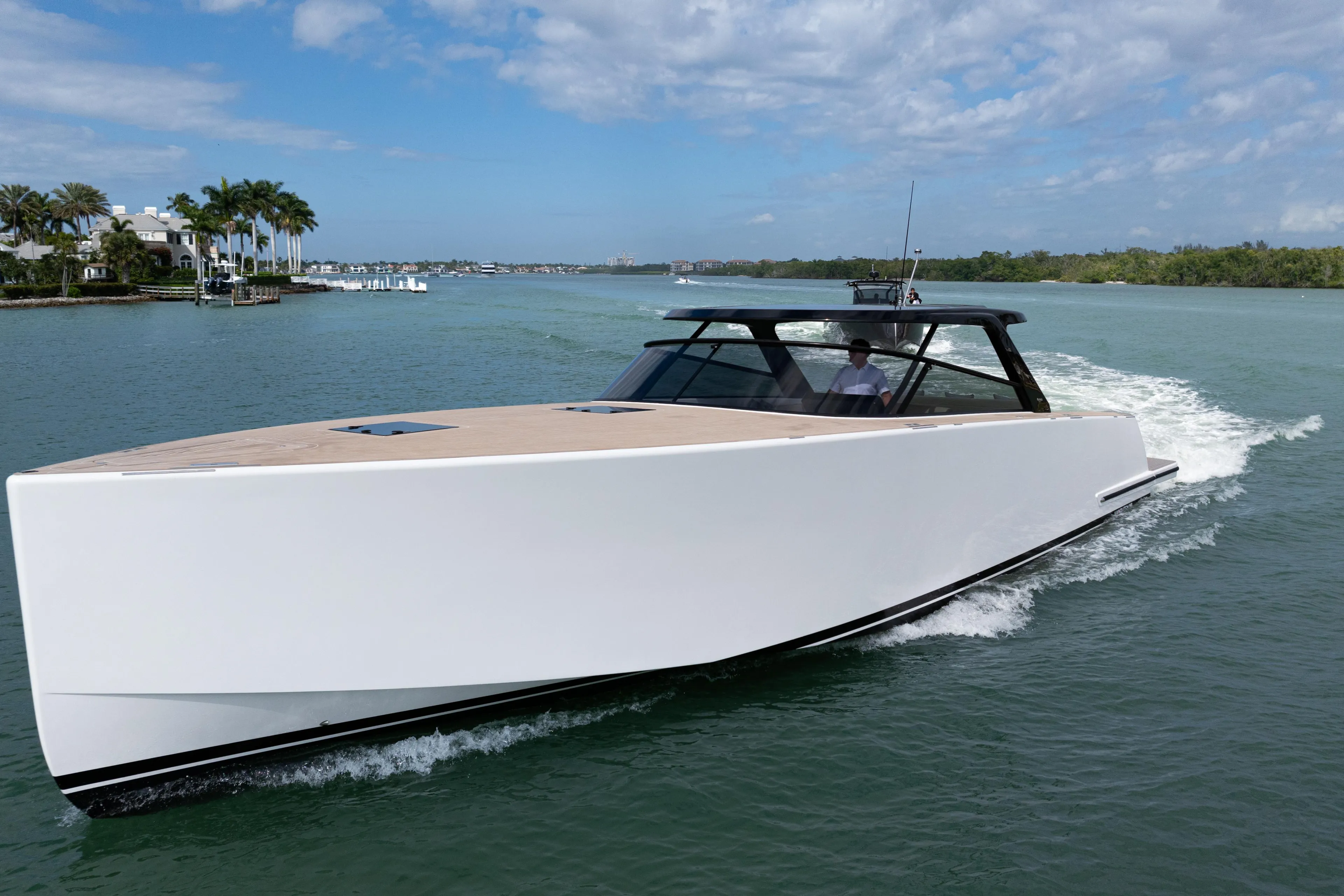 2024 VanDutch 56 yacht cruising on a sunny day, sleek design, open water.