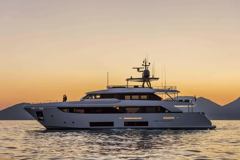  Yacht Photos Pics Luxurious 2025 Custom Line Navetta 33 yacht at sunset on calm waters.