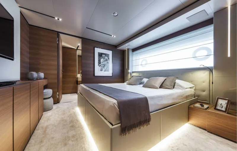  Yacht Photos Pics Luxurious bedroom interior on 2025 Custom Line Navetta 33 yacht, featuring modern design and ambient lighting.