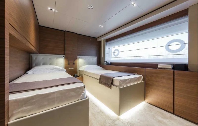  Yacht Photos Pics Luxurious twin bedroom in 2025 Custom Line Navetta 33 yacht, featuring modern wood paneling.