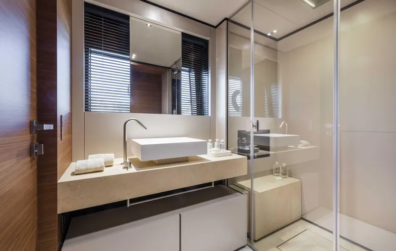  Yacht Photos Pics Luxurious bathroom in 2025 Custom Line Navetta 33 yacht, featuring modern sink and glass shower.