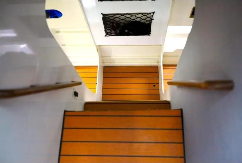 Hiolani II Yacht Photos Pics Interior stairs of 1988 CSK Polycon boat with wooden steps and handrails.
