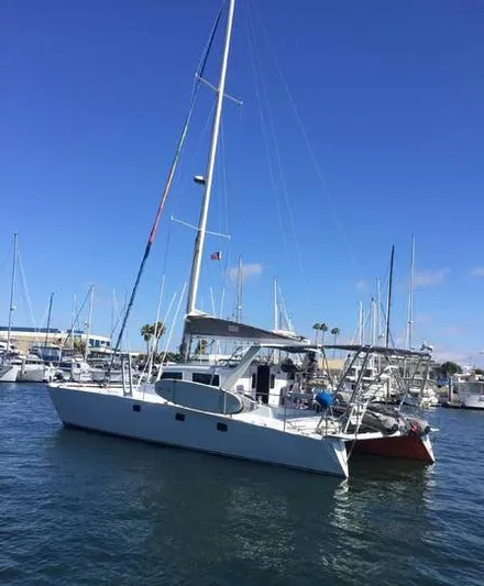 Hiolani II Yacht Photos Pics 1988 CSK Polycon sailboat docked in a marina under a clear blue sky.