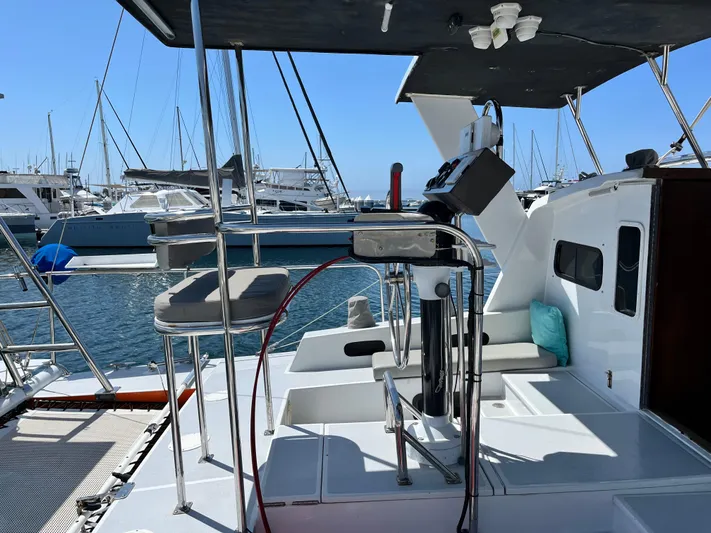 Hiolani II Yacht Photos Pics 1988 CSK Polycon yacht deck with steering wheel, seating, and marina view.