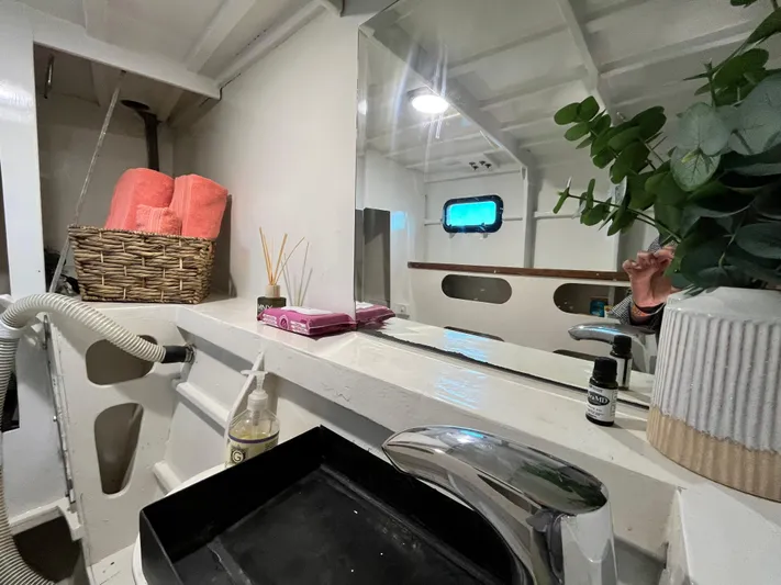 Hiolani II Yacht Photos Pics 1988 CSK Polycon boat interior with sink, mirror, and decor elements.