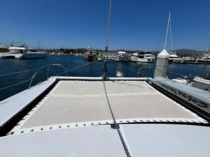 Hiolani II Yacht Photos Pics 1988 CSK Polycon catamaran docked at marina, clear blue sky, calm waters.
