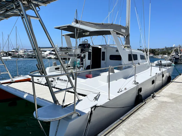 Hiolani II Yacht Photos Pics 1988 CSK Polycon sailboat docked at marina under clear blue sky.