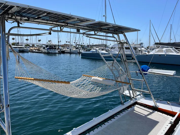 Hiolani II Yacht Photos Pics Hammock on CSK Polycon 1988 boat, docked in marina with sailboats.