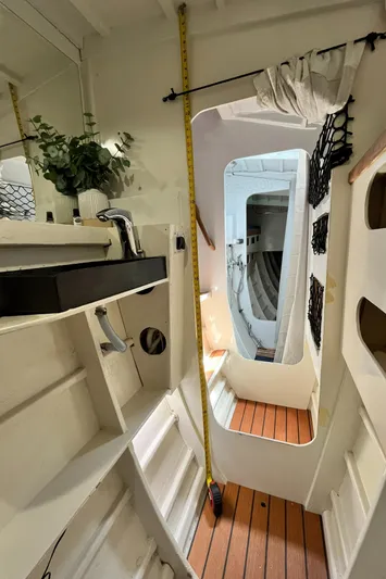 Hiolani II Yacht Photos Pics Interior of 1988 CSK Polycon boat with wooden flooring and modern fixtures.