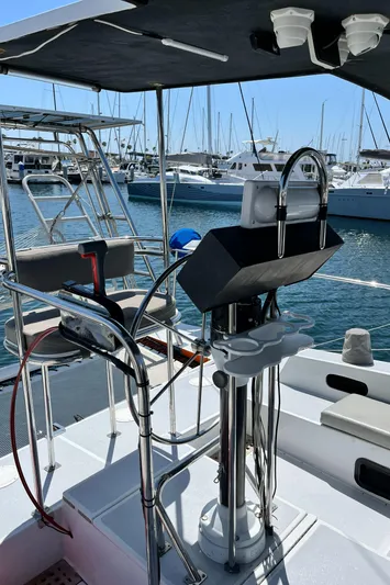 Hiolani II Yacht Photos Pics 1988 CSK Polycon boat helm with marina view, featuring modern steering and navigation equipment.