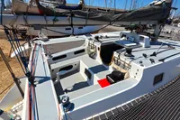 Custom TRIMARAN PULSAR 33 sailboat, 2002 model, docked with visible deck and rigging.