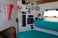 Interior of 2002 Custom TRIMARAN PULSAR 33 with navigation equipment and teal seating.