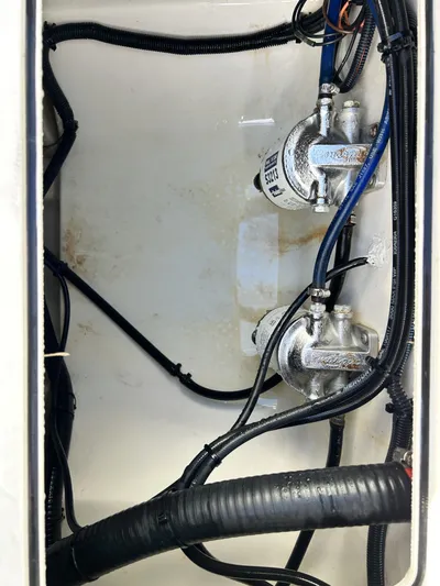 Crank It Up Yacht Photos Pics Interior view of 2006 Boston Whaler 320 Outrage, showing wiring and pumps.