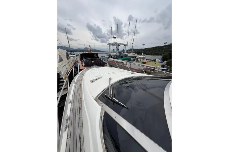  Yacht Photos Pics 2005 Cantieri di Sarnico 50 yacht docked at marina under cloudy sky.