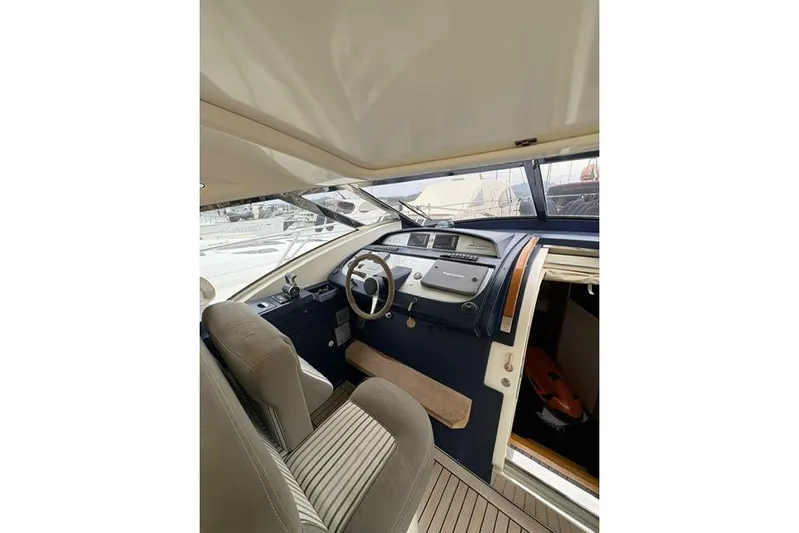  Yacht Photos Pics Interior of 2005 Cantieri di Sarnico 50 yacht, featuring helm and seating area.