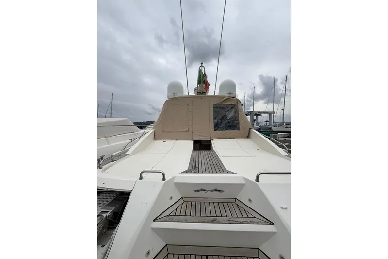  Yacht Photos Pics 2005 Cantieri di Sarnico 50 yacht with covered deck, docked under cloudy skies.