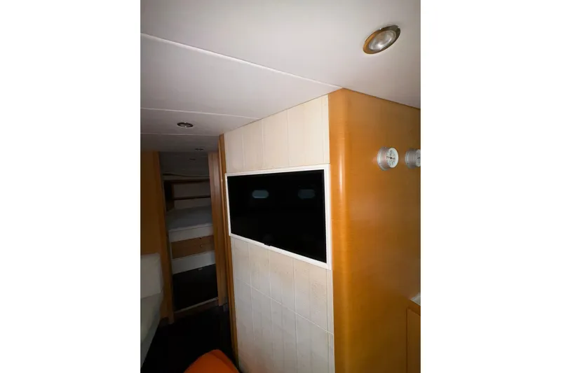  Yacht Photos Pics Interior of 2005 Cantieri di Sarnico 50 yacht with modern TV and wood paneling.