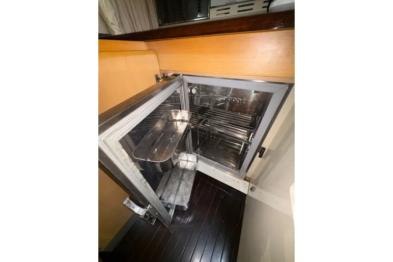  Yacht Photos Pics Open refrigerator inside 2005 Cantieri di Sarnico 50 yacht, showcasing interior shelves.