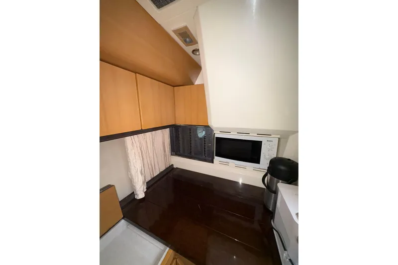  Yacht Photos Pics Compact kitchen area in a 2005 Cantieri di Sarnico 50 yacht with modern appliances.