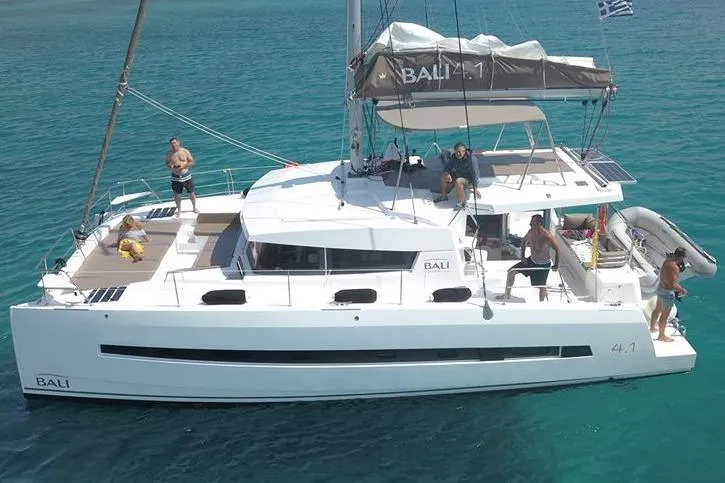Double Kiss Yacht Photos Pics 2018 Bali 4.1 catamaran sailing on clear blue water with passengers enjoying the deck.