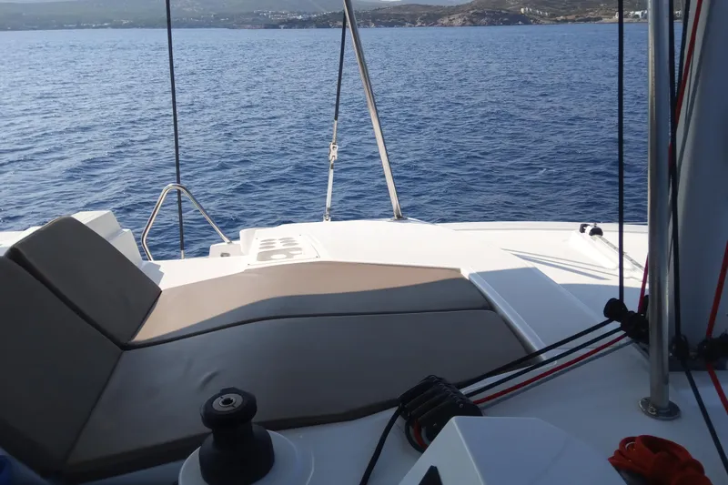 Double Kiss Yacht Photos Pics Luxurious Bali 4.1 catamaran deck with seating, overlooking serene blue ocean, 2018 model.