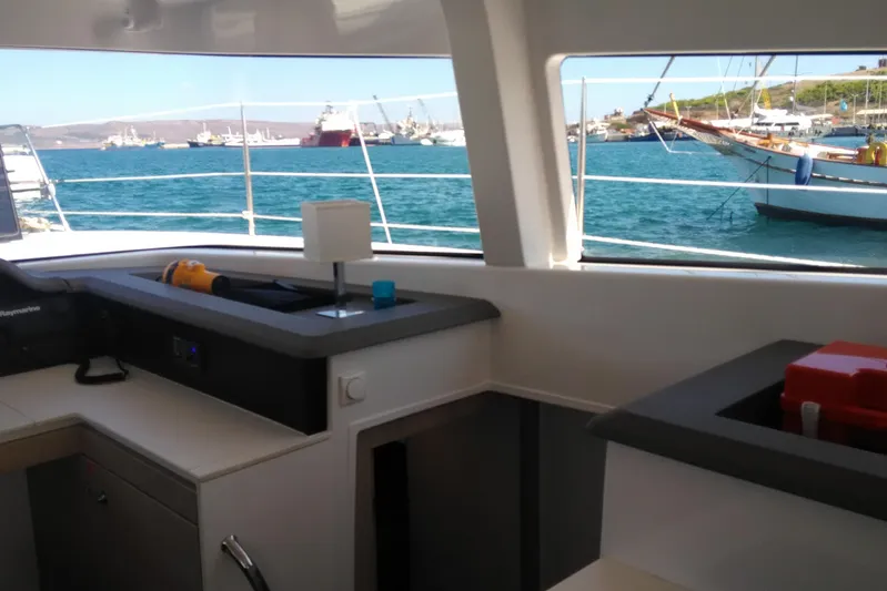 Double Kiss Yacht Photos Pics Interior view of a 2018 Bali 4.1 catamaran with ocean and boats outside.