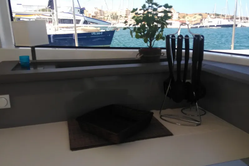Double Kiss Yacht Photos Pics Modern kitchen on Bali 4.1 yacht with sea view, utensils, and potted plant.