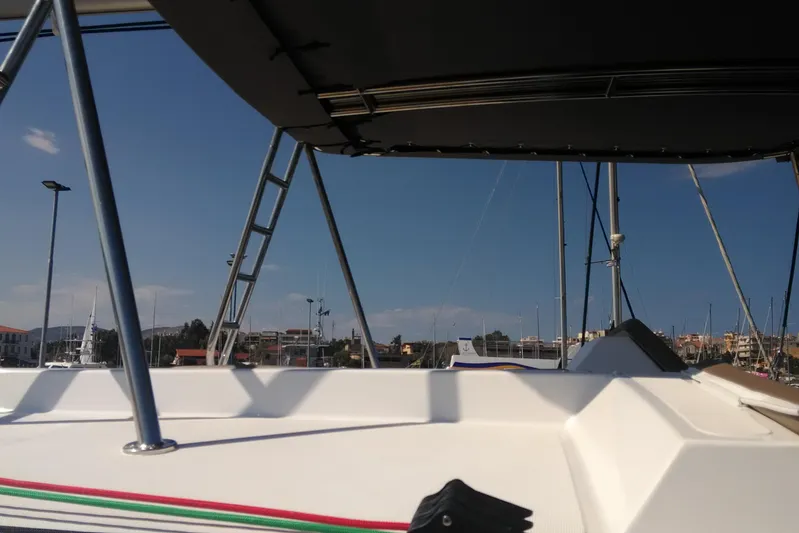 Double Kiss Yacht Photos Pics Bali 4.1 catamaran deck view, 2018 model, with marina background under clear blue sky.