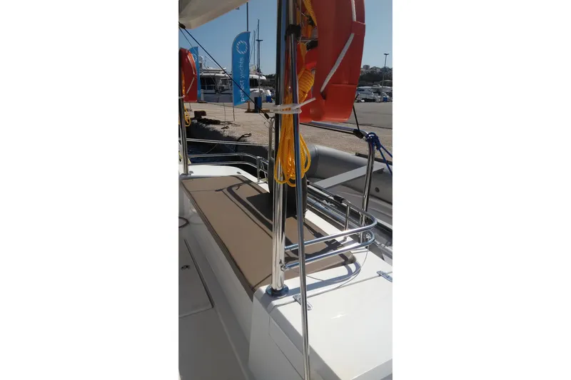 Double Kiss Yacht Photos Pics 2018 Bali 4.1 yacht deck with safety equipment and dock view.
