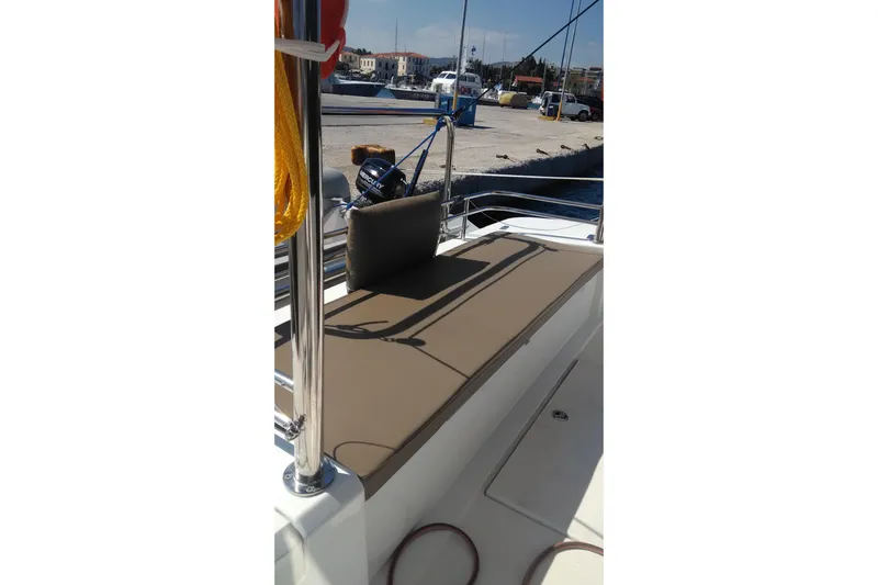 Double Kiss Yacht Photos Pics 2018 Bali 4.1 yacht deck with cushioned seating at a marina.