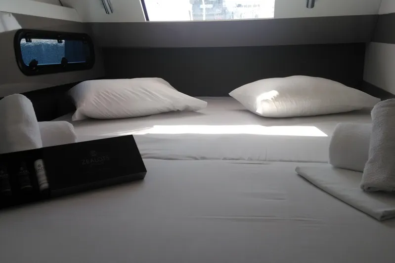 Double Kiss Yacht Photos Pics Luxurious cabin interior of 2018 Bali 4.1 yacht with pillows and toiletries.