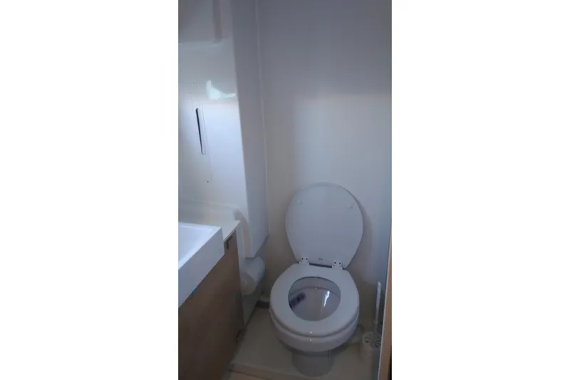 Double Kiss Yacht Photos Pics Compact bathroom in 2018 Bali 4.1 model, featuring a toilet and sink.