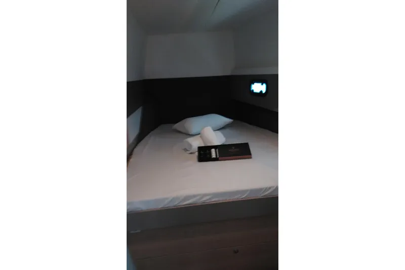 Double Kiss Yacht Photos Pics Cozy cabin interior of 2018 Bali 4.1 yacht with bed and porthole.