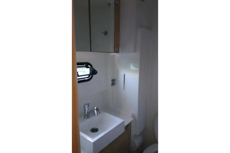 Double Kiss Yacht Photos Pics Compact bathroom in a 2018 Bali 4.1 yacht, featuring a sink and mirror.