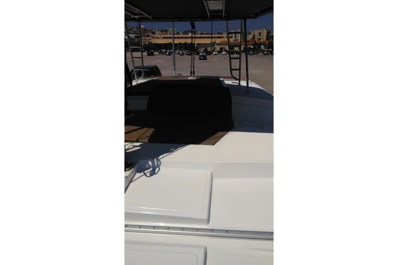 Double Kiss Yacht Photos Pics 2018 Bali 4.1 catamaran deck with seating area, parked in a marina.