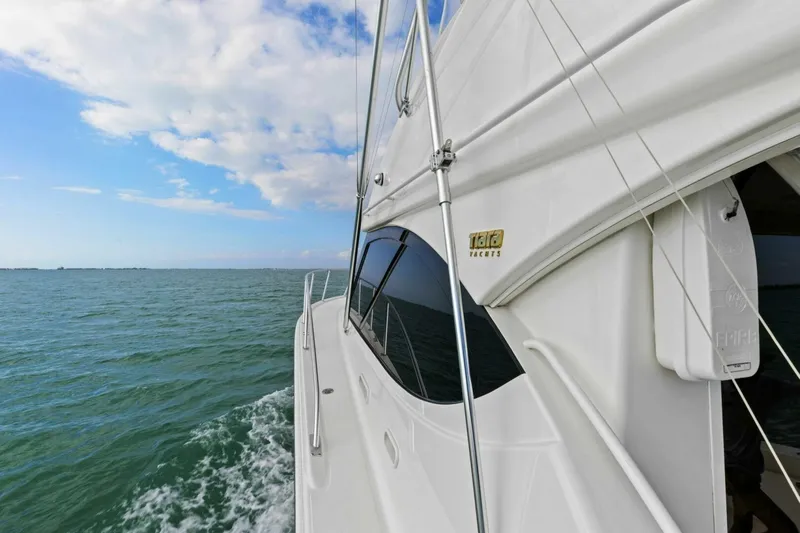 Salty Dach Yacht Photos Pics 2013 Tiara Yachts 3900 Convertible cruising on open water under a partly cloudy sky.