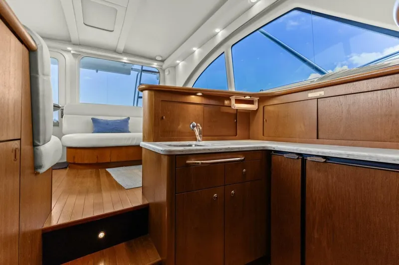 Salty Dach Yacht Photos Pics Luxurious interior of 2013 Tiara Yachts 3900 Convertible with wood cabinetry and seating.