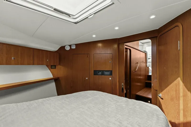 Salty Dach Yacht Photos Pics 2013 Tiara Yachts 3900 Convertible cabin interior with wood paneling and modern lighting.